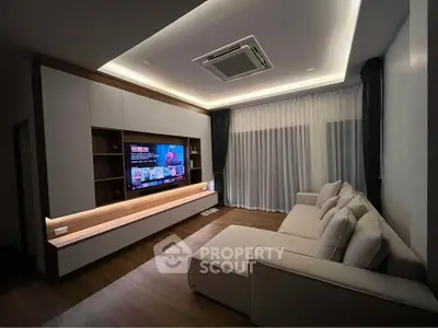 Modern living room with sleek entertainment center and cozy sectional sofa, perfect for relaxation and entertainment.