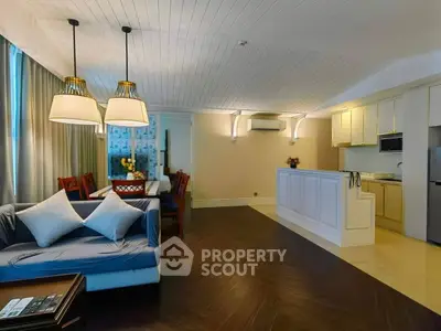 Elegant open-layout living room with modern kitchen and stylish lighting