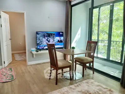 Cozy living room with dining set and balcony view, perfect for relaxation.