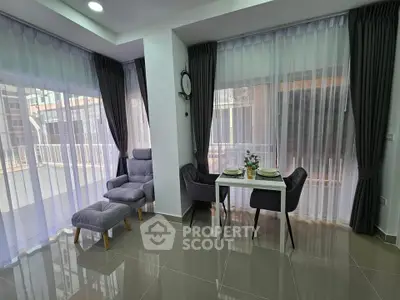 Modern living room with elegant dining area and large windows