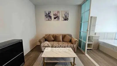Modern living room with stylish decor and sliding glass door to bedroom