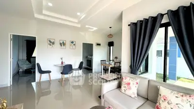 Modern open-plan living room with elegant decor and natural light