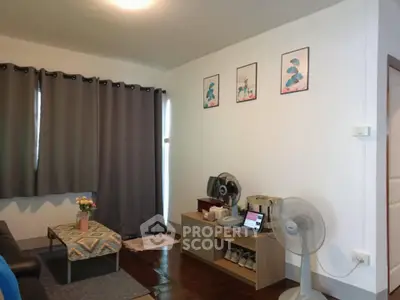 Cozy living room with modern decor, featuring a comfortable sofa, stylish artwork, and natural light.