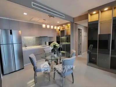 Modern kitchen with sleek design, featuring stainless steel appliances and elegant dining area.