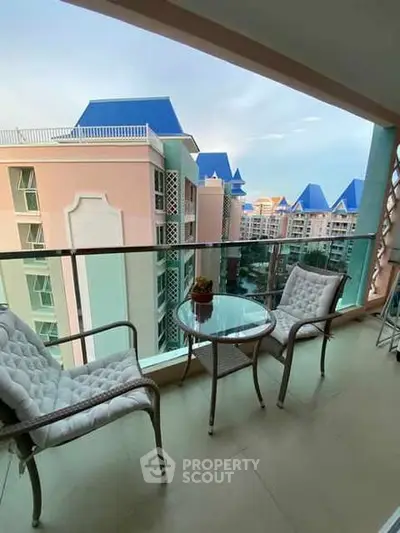Charming balcony with cozy seating and stunning view of colorful buildings.