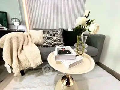 Stylish living room with cozy sofa, chic decor, and elegant coffee table setup.