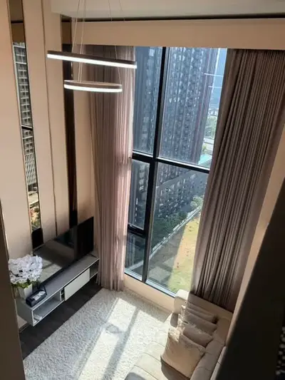 Luxurious high-rise living room with floor-to-ceiling windows and modern decor.