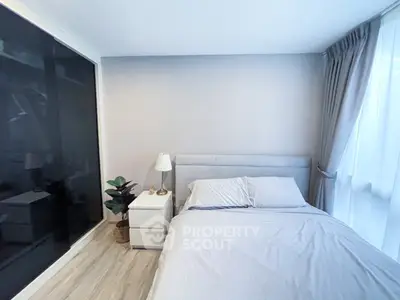 Cozy bedroom with modern decor and ample natural light