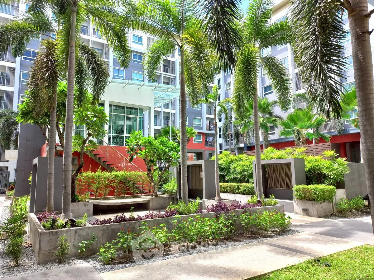 Luxurious modern apartment complex with lush landscaped garden and palm trees