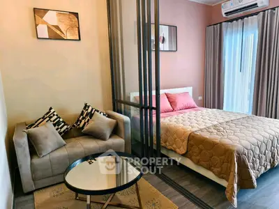Modern studio apartment with cozy bed and stylish sofa in open layout.