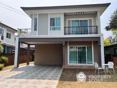 Modern two-story house with spacious driveway and small patio area.