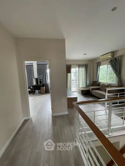 Spacious living area with modern decor and large windows for natural light