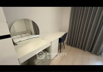 Modern bedroom with stylish vanity and study desk, featuring elegant curtains and minimalist design.