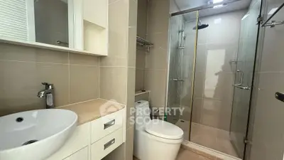 Modern bathroom with sleek fixtures and glass shower enclosure
