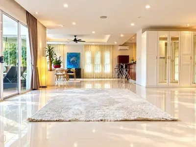 Spacious open-plan living room with modern decor and large windows
