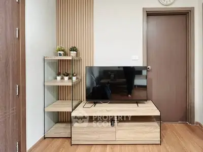 Modern living room with sleek TV stand and wooden flooring, perfect for cozy entertainment.
