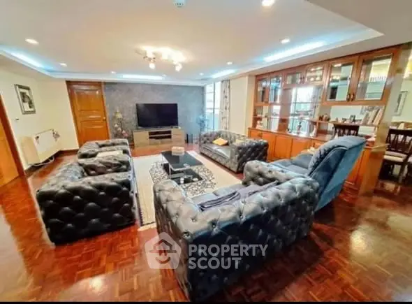 Luxurious living room with elegant leather sofas and modern decor in a spacious apartment.