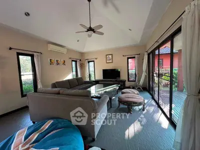 Spacious living room with large windows and modern decor