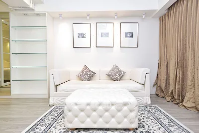 Elegant living room with plush white sofa, stylish decor, and cozy ambiance.