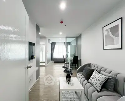 Modern open-plan living room with stylish decor and natural light