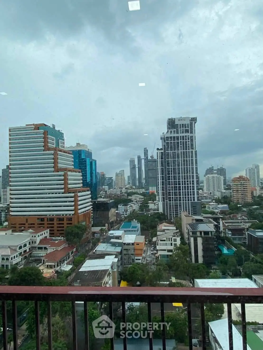 Stunning cityscape view from a high-rise balcony showcasing modern urban architecture and skyline.