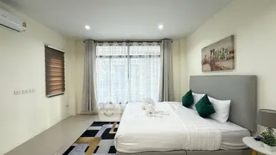 Spacious modern bedroom with elegant decor and natural light