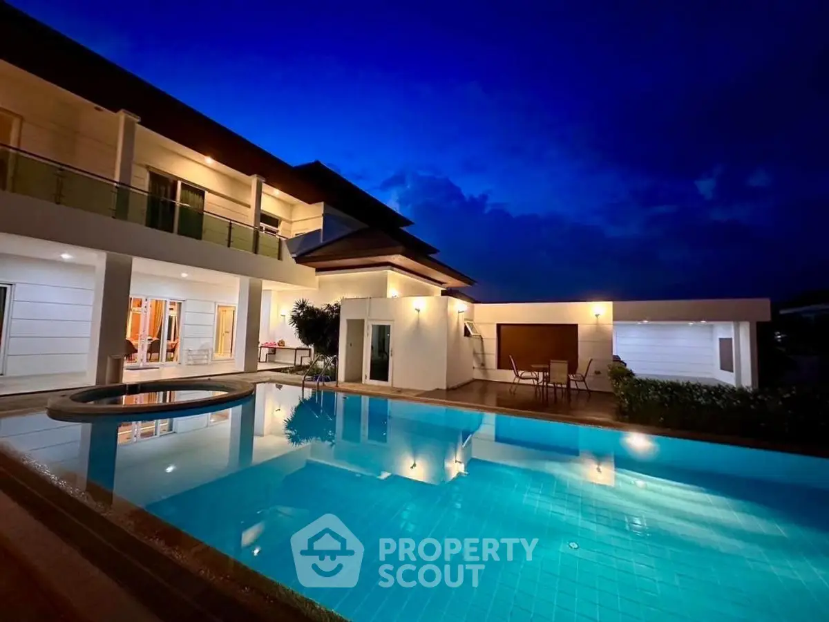 Luxurious modern villa with stunning pool and elegant lighting at dusk