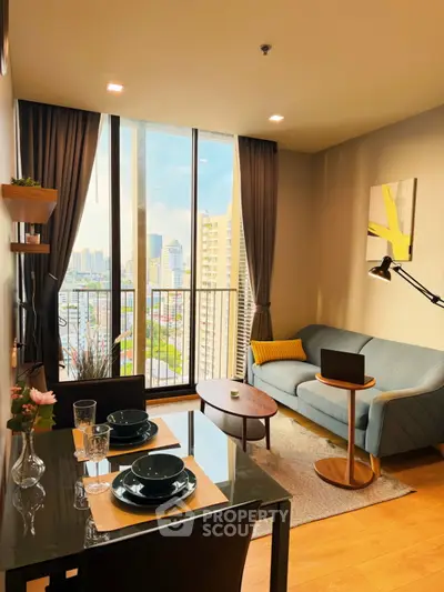 Modern living room with city view, stylish decor, and floor-to-ceiling windows in urban apartment.