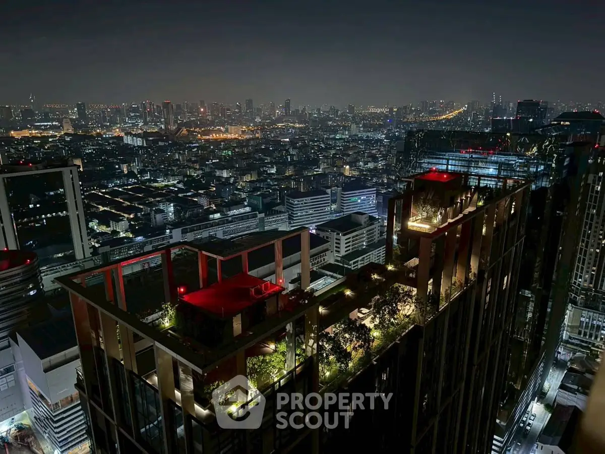 Stunning rooftop view of a modern cityscape at night, showcasing luxurious urban living.
