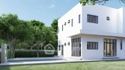 Modern white house with large windows and private pool in lush green setting.