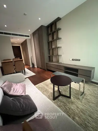 Modern living room with stylish furniture and built-in shelving in a contemporary apartment.