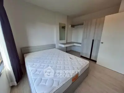 Spacious bedroom with modern furnishings and ample natural light