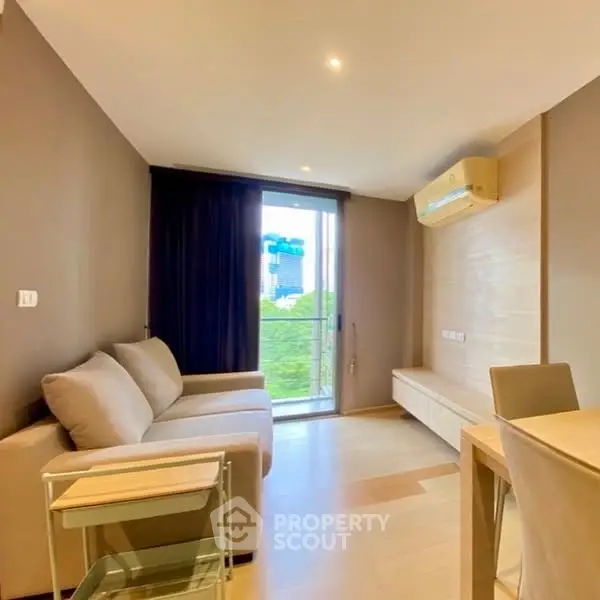 Modern living room with balcony view and stylish furniture in urban apartment.