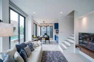Modern living room with pool view, stylish decor, and open layout in luxury home.