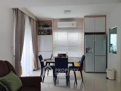 Modern dining area with sleek furniture and large windows in a stylish apartment.