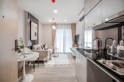 Modern open-plan living room and kitchen with sleek design and natural light.
