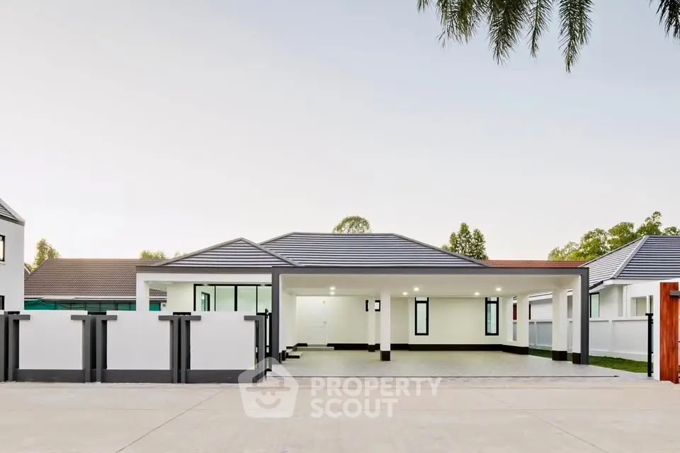 Modern single-story house with sleek design and spacious driveway