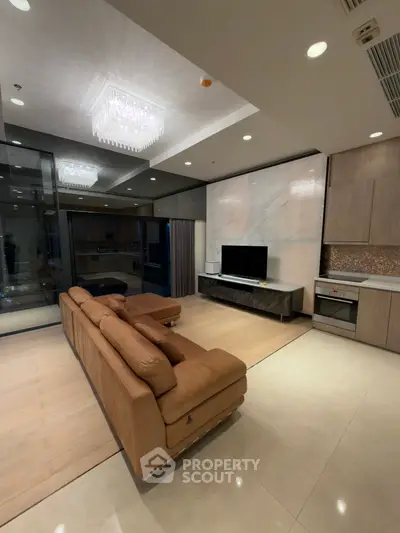 Luxurious modern living room with elegant lighting and sleek kitchen appliances
