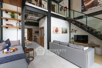 Modern loft-style living room with high ceilings and stylish decor