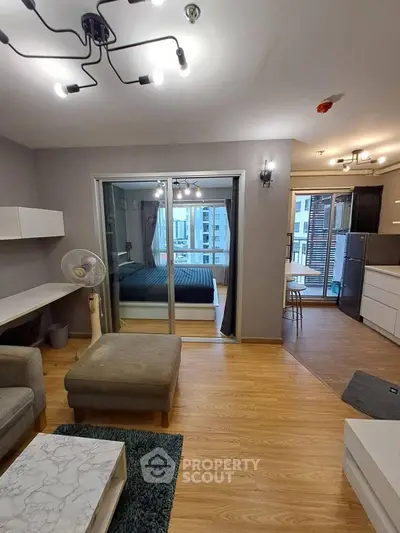 Modern open-plan living room with stylish decor and city view balcony