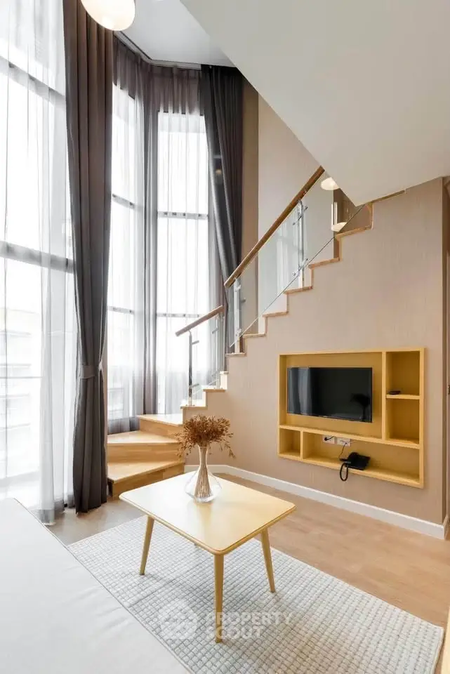 Modern living room with high ceilings and stylish staircase