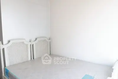 Minimalist bedroom with white walls and classic headboard