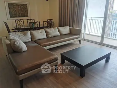 Spacious living room with modern furniture and balcony access