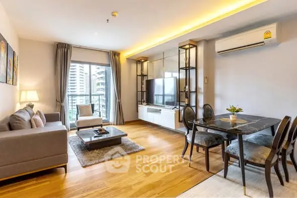 Modern living room with elegant decor, wooden flooring, and large window offering city view.