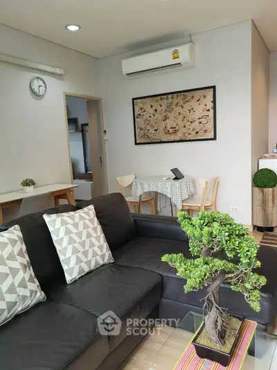 Modern living room with stylish decor and comfortable seating in a cozy apartment.