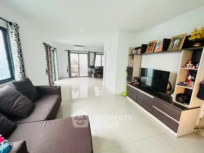 Spacious living room with modern decor and ample natural light