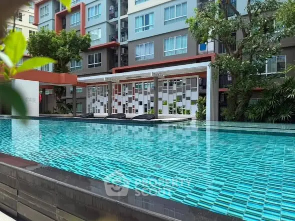 Luxurious apartment complex with modern pool and stylish exterior design.