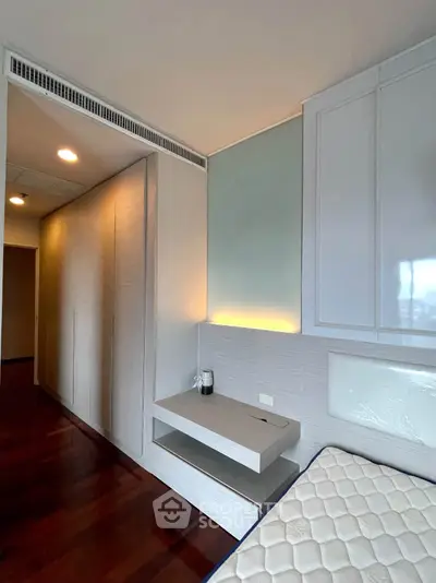 Modern bedroom with sleek built-in wardrobe and stylish lighting