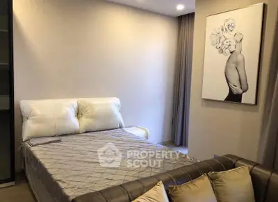 Modern bedroom with stylish decor and cozy bedding in a contemporary apartment.