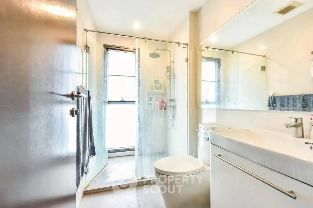 Modern bathroom with glass shower and sleek fixtures
